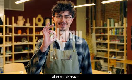 Caucasian man portrait smiling guy sculptor potter craftsman in pottery workshop designer artisan male small business owner craft shop art studio Stock Photo
