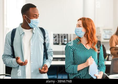 International students wearing medical masks and talking Stock Photo
