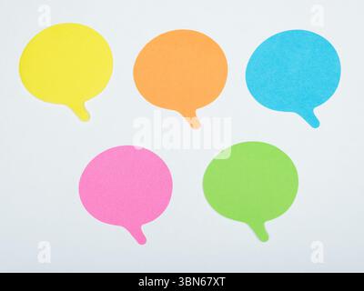 Five colorful speech bubbles arranged on a white background, representing communication, ideas, or dialogue. Stock Photo