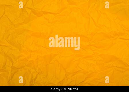 Textured surface of crumpled yellow paper. Stock Photo