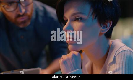 Business people man woman working computer teamwork discussion online project at night overtime office Caucasian businessman businesswoman Stock Photo