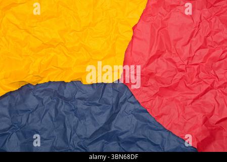 Crumpled paper in bold red, yellow, and blue. Stock Photo