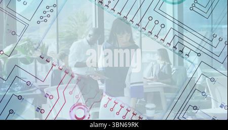 Circuit pattern image over diverse professionals working in modern office Stock Photo