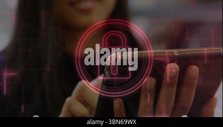 Woman holding smartphone in landscape and tapping touchscreen in office, with padlock icon overlay Stock Photo