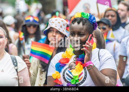 Portrait of young woman in vibrant rainbow colors celebrating 10 years of marriage equality at Dublin Pride Parade. 28 June 2025 Stock Photo