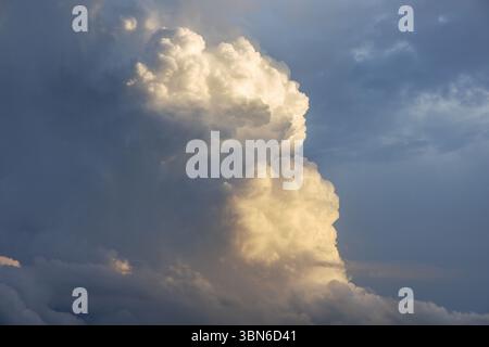 Towering cumulonimbus clouds in Iowa during a summer sunset. Stock Photo
