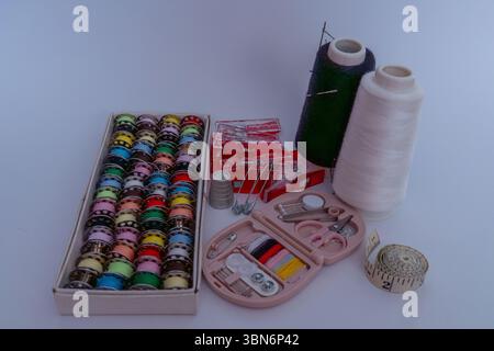 Various sewing accessories on white background Stock Photo
