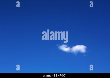 Blue sky one alone white cloud scene. White cloud in clear blue sky. Nice blue sky white cloud background Stock Photo