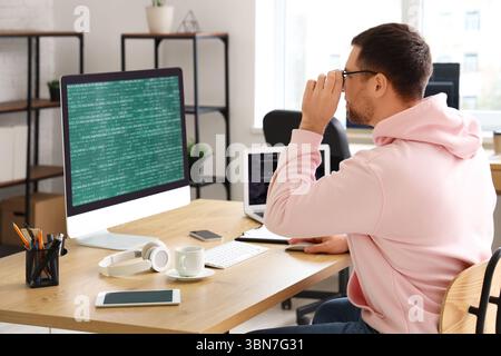 Portrait of focused male programmer working in office Stock Photo