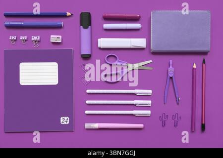 Different stationery on purple background Stock Photo