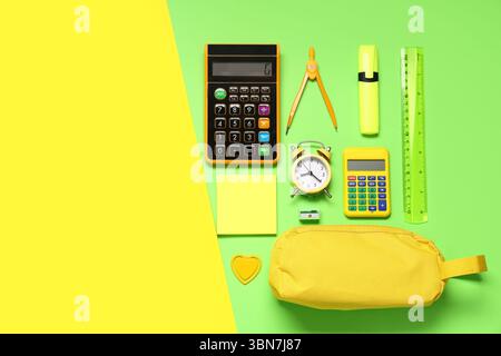 Composition with alarm clock, calculator and different school stationery on color background Stock Photo