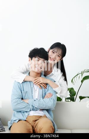 Young couple embracing on the sofa Stock Photo