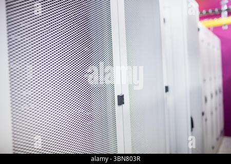 Central server cabinet door is being shown in flat design data center aisle, featuring yellow trays Stock Photo
