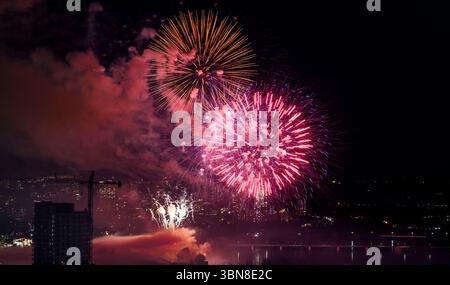 Fireworks explode above the Ottawa River and LeBreton Flats Park on Canada Day in Ottawa on Monday, July 1, 2024. THE CANADIAN PRESS/Justin Tang Stock Photo