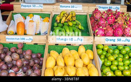 a variety of fruits displayed for sale at a market with price tags, Chinatown, Bangkok, Thailand Stock Photo