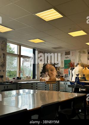 Art classroom with sewing machines and student artwork. Stock Photo