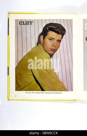 1960s Vintage magazine annual  page featuring Cliff Richard as a young man in yellow shirt with styled hair against striped background Stock Photo
