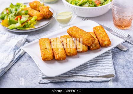 Fried potato pocked filled with cream cheese and herbs with mixed salad Stock Photo