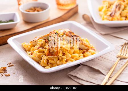 German egg dumplings with bacon, fried onions and grilled Halloumi cheese Stock Photo