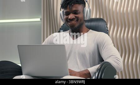 Futurism African American man male programmer developer smiling cyber data guy in white futuristic room indoors cyberspace modern technology wearing Stock Photo