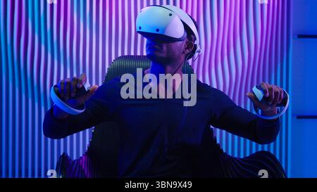 African American man guy male gamer gaming vr play wearing virtual reality glasses helmet three dimension game modern cyber technology neon futurism Stock Photo
