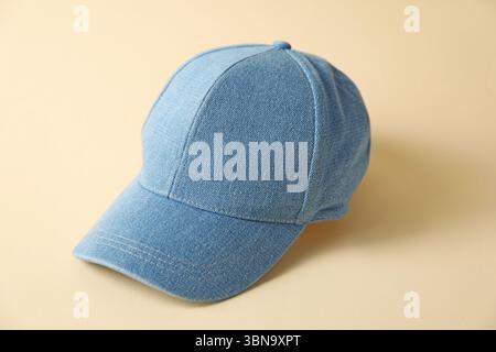 Denim baseball hat on beige background, closeup Stock Photo