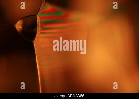 Orange coloured liquid surface, fluid effect, bright chemistry Stock Photo