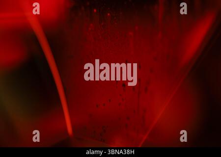 Red reflections of liquid in macro, red liquid surface, bubbles in macro, connection of bubbles in macro, cell from liquid, horror background Stock Photo