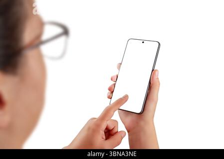 Woman interacting with smartphone, blank screen ideal for app mockups, user interface previews, or digital product presentations Stock Photo