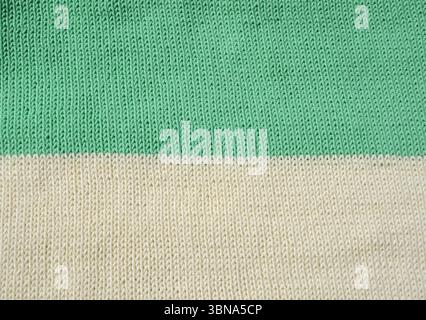 A detailed macro shot shows a mint milk knit fabric. The stockinette stitch with neat vertical V-shaped patterns creates a soft, even and textured sur Stock Photo