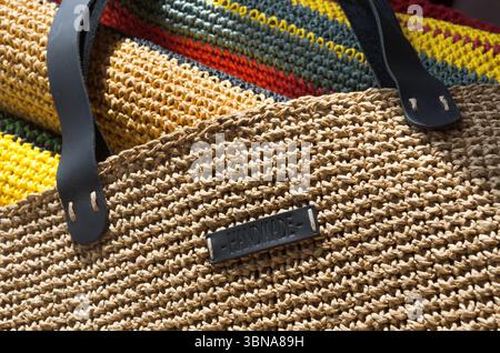 Handmade beach bag made of multi-colored ECO raffia. Palm leaf for knitting bags and various beach accessories. Stock Photo