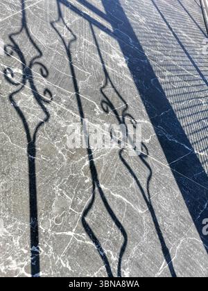 Intricate shadows are beautifully cast on a polished marble surface, showcasing elegant patterns and textures, while the interplay of light adds depth Stock Photo