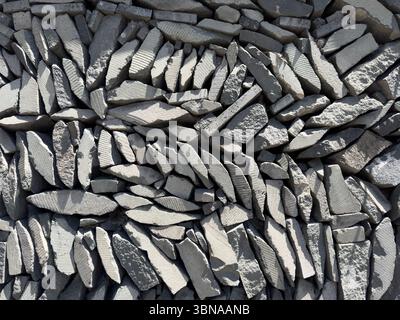 Background from a wall, background from stones neatly stacked on top of each other, fence from stones. There are some small holes in the wall Stock Photo
