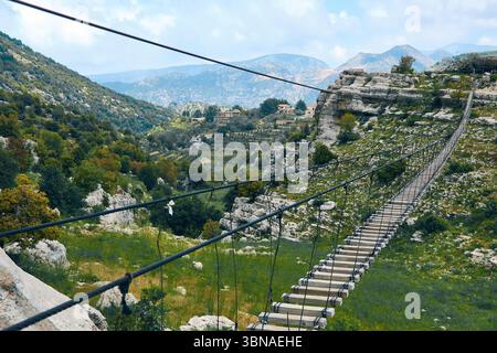 Suspension bridge crossing mountain valley Stock Photo