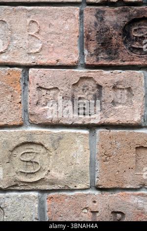 Budapest, Hungary – the enchanting Pearl of the Danube., A close-up view of a brick wall, composed of rectangular bricks in shades of beige, brown, and reddish-brown. The bricks are arranged in a regular pattern, creating a sense of order and structure. The mortar between the bricks is a light gray or off-white. The bricks are weathered and show signs of age and use, with some areas appearing darker or more worn than others. The image does not contain any discernible text or countable Stock Photo