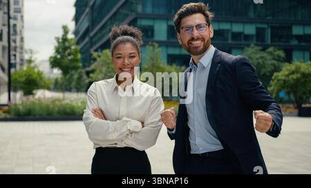 Two multiracial colleagues multiethnic coworkers people Caucasian business man male guy businessman African woman businesswoman female girl together Stock Photo