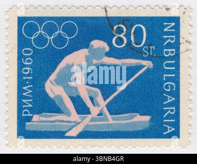 BULGARIA — 1960 August 29: 80 stotinki blue and pink postage stamp depicting Canoeing. 17th Olympic Games, Rome, 25 August — 11 September. The Bulgarian Olympic Committee was created in 1923 and first sent a team to the Summer Olympic Games in 1924. The nation has participated in every Summer Games since then, except for 1932 (during the Great Depression), 1948 (Bulgaria's role in World War II) and 1984 (part of the Soviet-led boycott of the 1984 Summer Olympics) Stock Photo