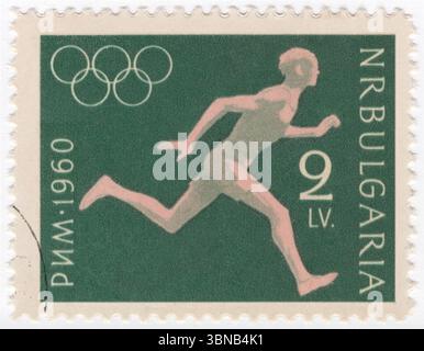 BULGARIA — 1960 August 29: 2 leva deep green and pink postage stamp depicting Runner. 17th Olympic Games, Rome, 25 August — 11 September. The Bulgarian Olympic Committee was created in 1923 and first sent a team to the Summer Olympic Games in 1924. The nation has participated in every Summer Games since then, except for 1932 (during the Great Depression), 1948 (Bulgaria's role in World War II) and 1984 (part of the Soviet-led boycott of the 1984 Summer Olympics) Stock Photo
