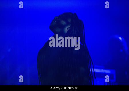 silhouette of DJs playing the mixer on stage at a party in a nightclub ...