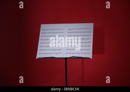 Note stand with music sheets on red background Stock Photo