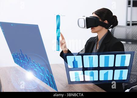 Building information modelling. Woman using virtual reality headset in office. Holographic screen with cityscape Stock Photo