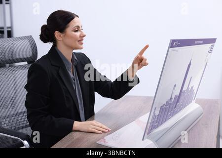 Building information modelling. Woman using virtual screen in office Stock Photo