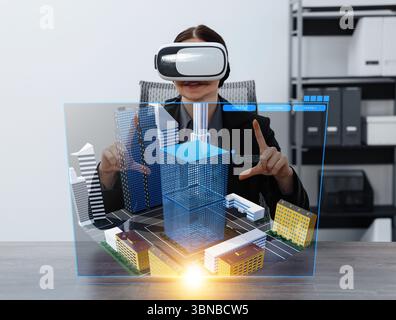 Building information modelling. Woman using virtual reality headset in office. Holographic screen with cityscape Stock Photo