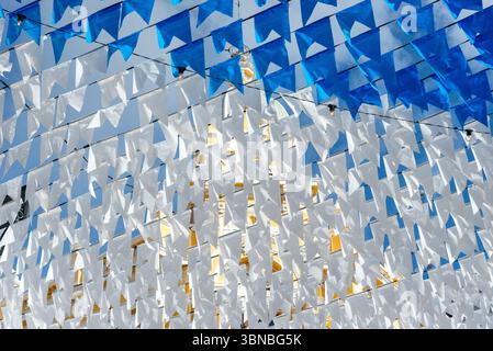 Decorative pennants for the festival of Saint John, colored and hung high up between buildings. June festival in Pelourinho. Stock Photo