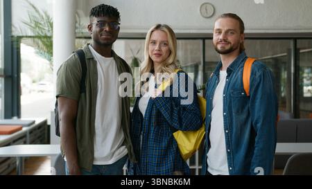 Portrait university college academy studying together education three students multiracial friendship multiethnic friends male men Caucasian African Stock Photo