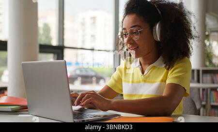 African American student girl female woman freelancer working studying laptop video call write task note talking distant virtual computer conference Stock Photo