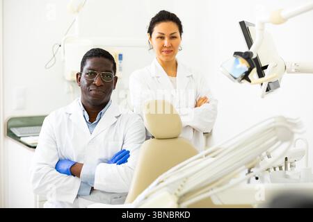 Two successful professional dentists in modern dental office Stock Photo