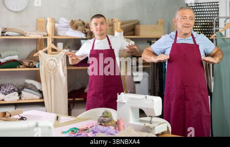Male tailors doing a warm-up at work Stock Photo
