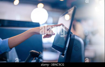Closeup of Human finger pointing on the glowing computer screen with blue Stock Photo