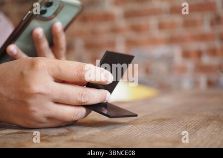 Woman use smartphone to scan QR code for order menu in cafe restaurant ...
